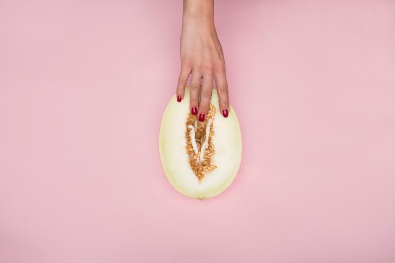 person holding sliced of green fruit