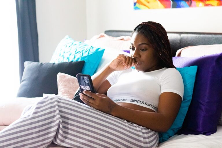 woman in white t-shirt lying on bed