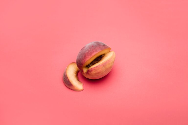 sliced apple fruit on pink surface