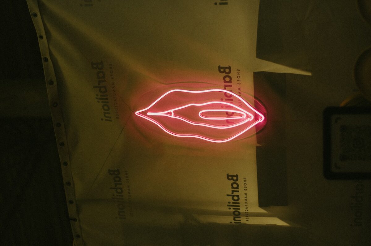 a red neon sign on the side of a wall